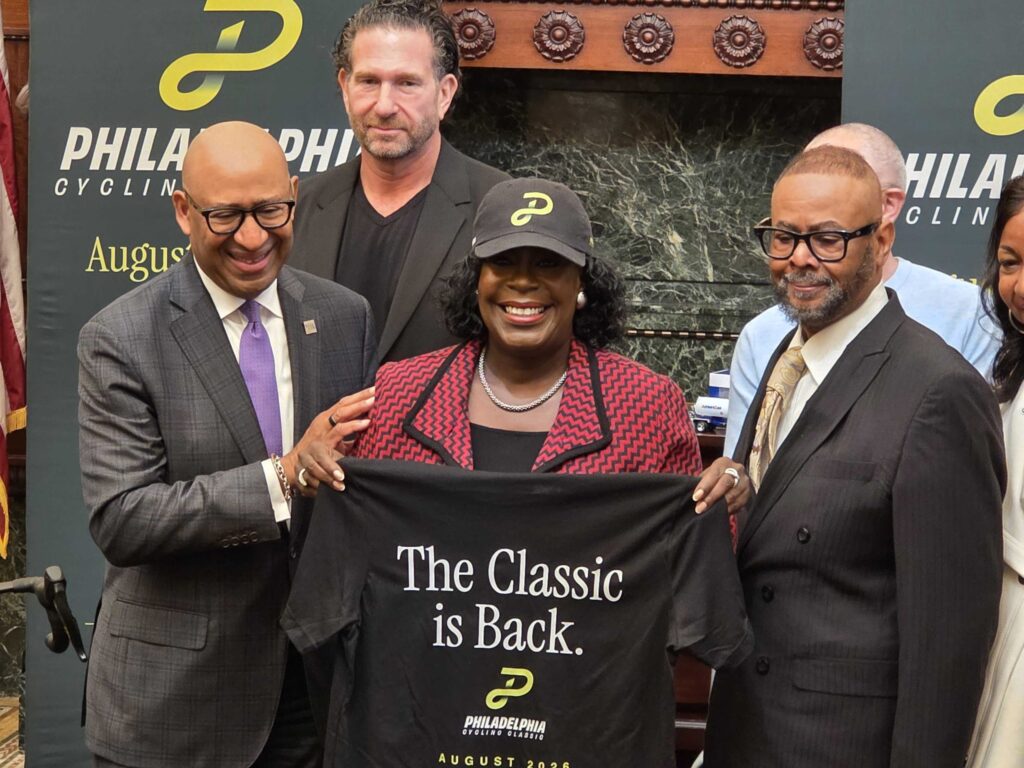 Mayor Parker holding up a t shirt at the press conference with other officials