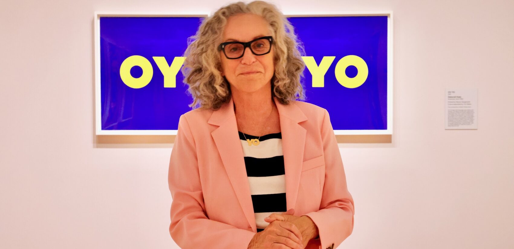 Deborah Kass stands before her ''OY/YO'' print