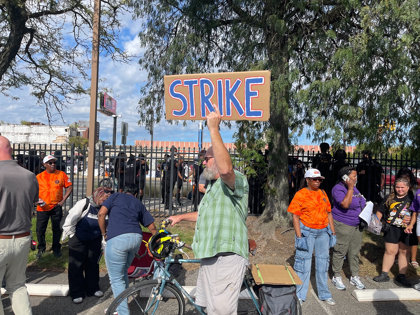 A man holds a sign reading STRIKE
