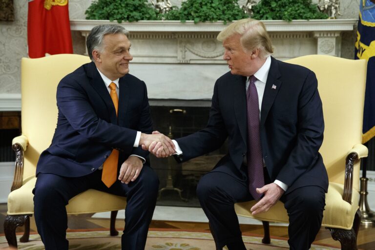 Donald Trump and Viktor Orbán shaking hands while sitting next to each other