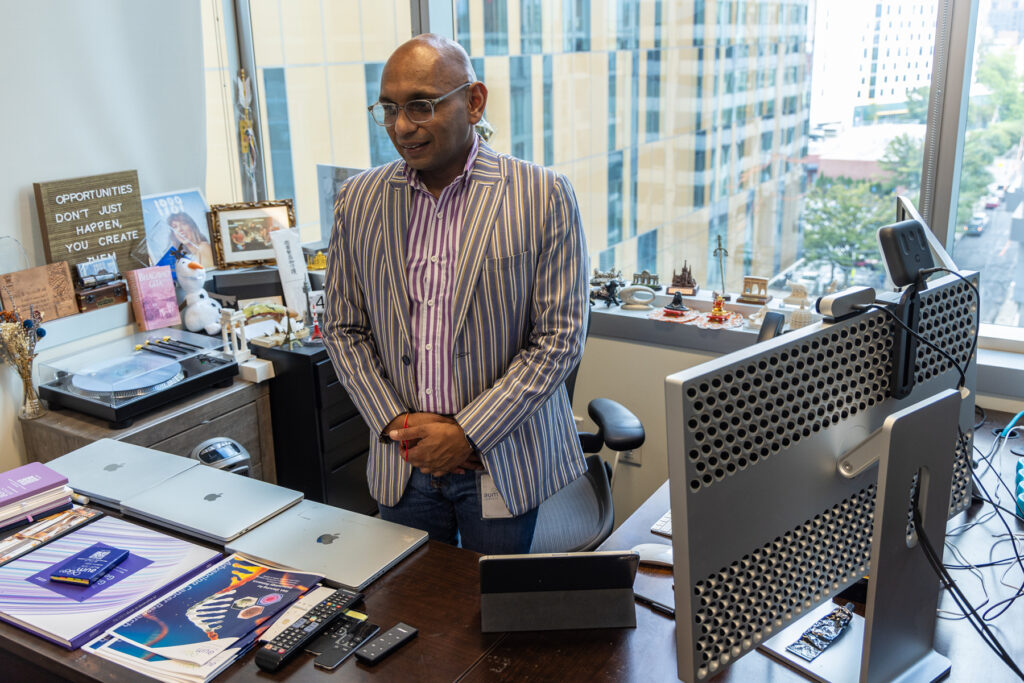 09 26 2025 k paynter AUM LifeTech Veenu Aishwarya hb1 visa story-2 copy Veenu Aishwarya, founder and CEO of AUM LifeTech, stands in his office