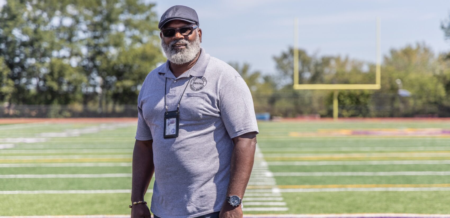 Warren Bethea posing for a photo on the football field