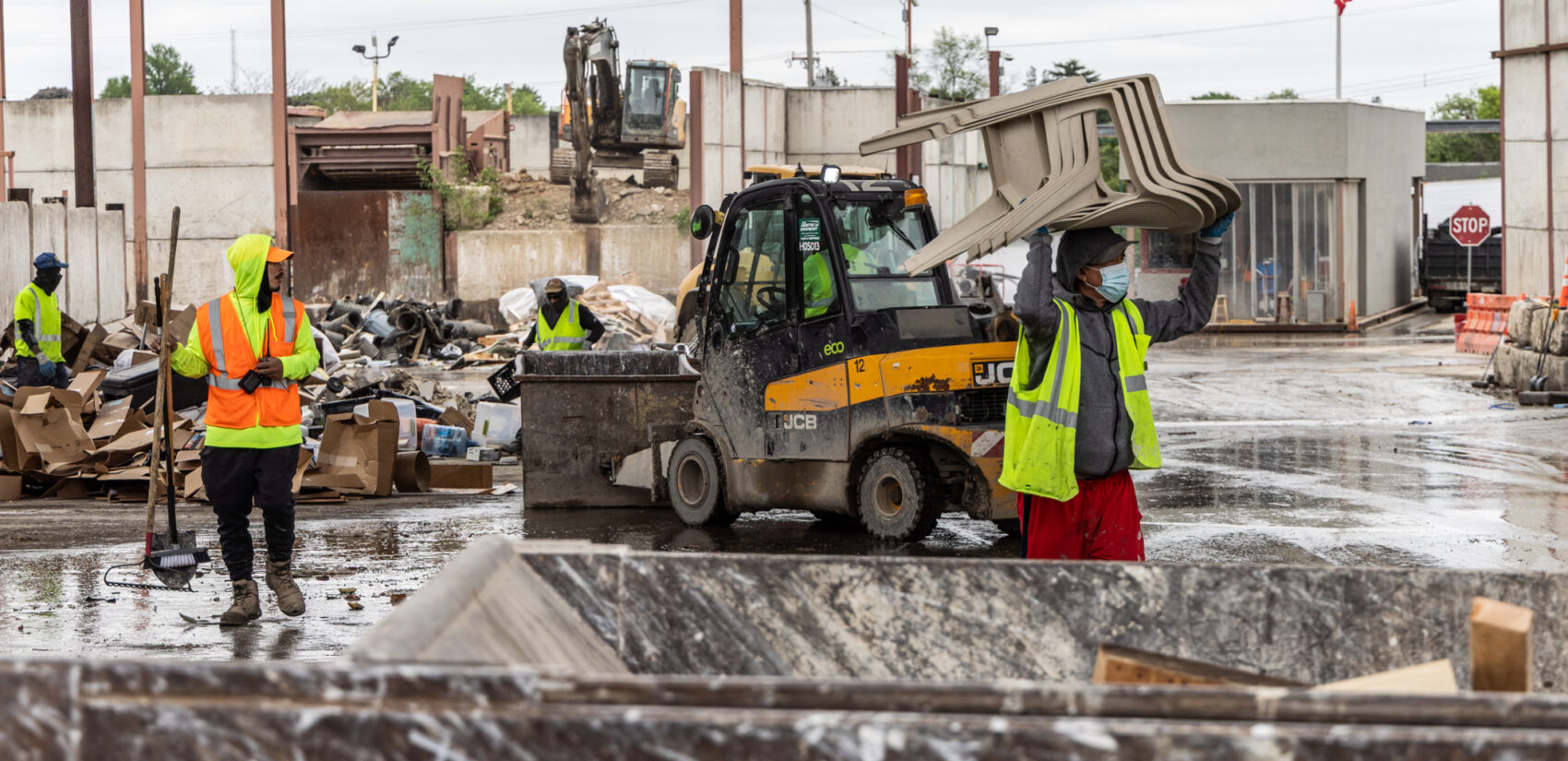 Workers moving recycling items