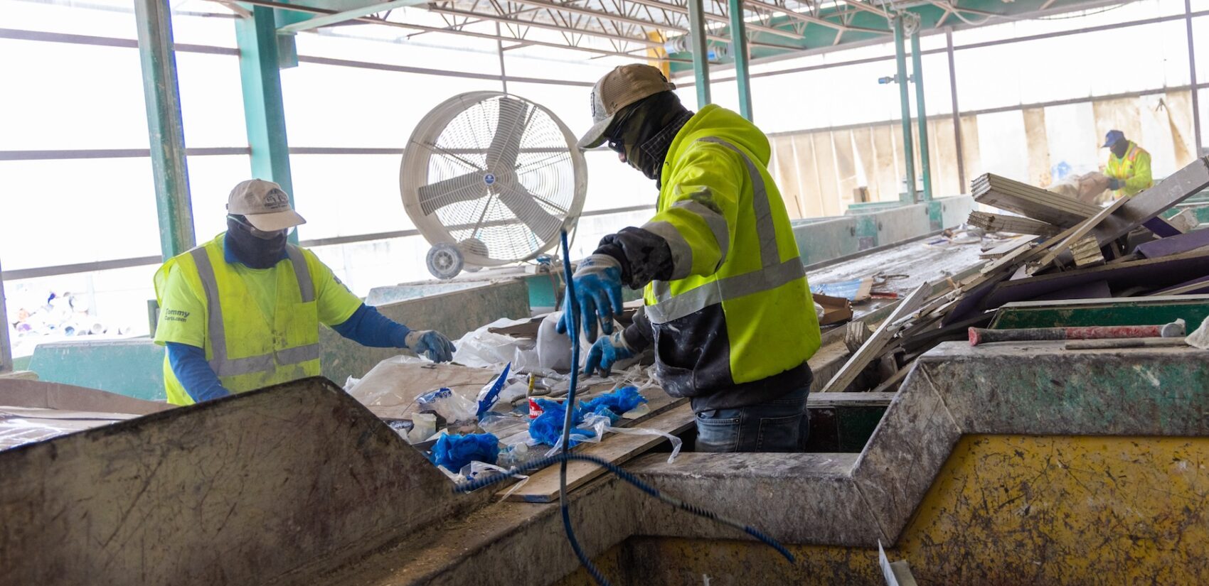 Workers sorting through recylcing