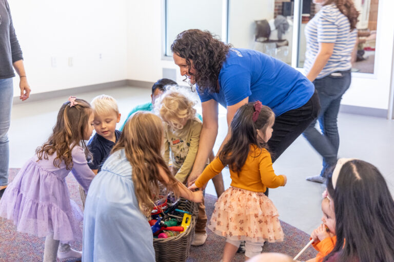 Norah Wasden cleans instruments with toddlers