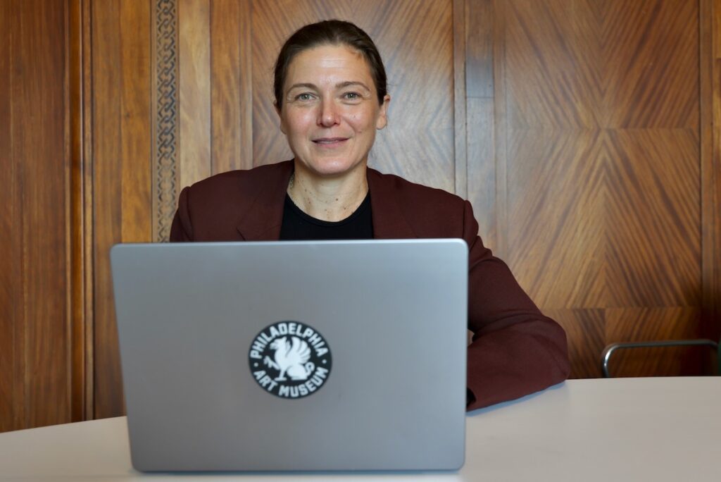Sasha Suda with new logo sticker on her laptop