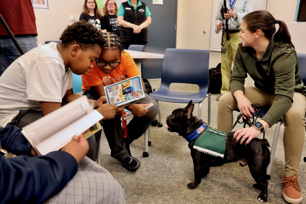 2025 10 22-e lee-philadelphia string theory school-therapy dogs reading maverick students reading alongside Maverick, a String Theory School therapy dog
