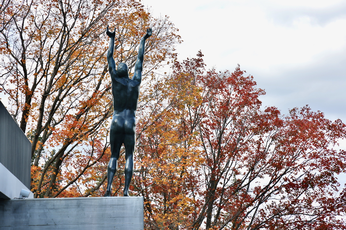 a statue outside Maguire Hall