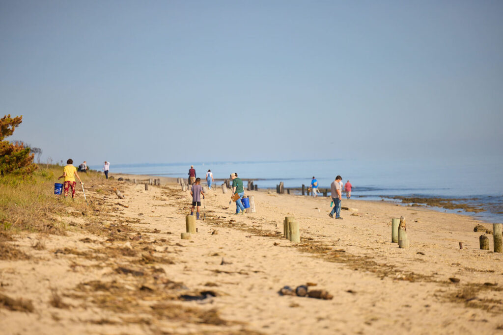 Volunteers picking up trash at the shore