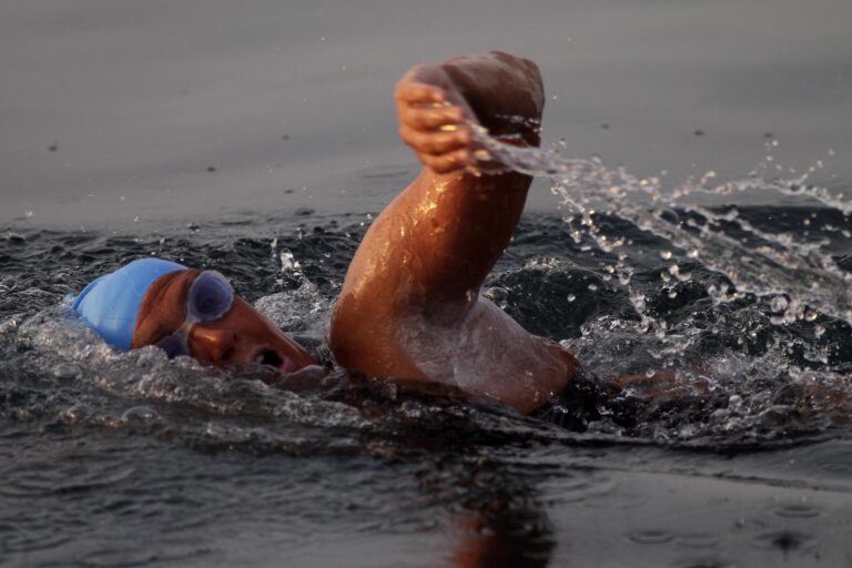 American endurance swimmer Diana Nyad , 61, swims in Cuban waters, offshore Havana, Cuba, Sunday, Aug. 7, 2011. Nyad jumped into Cuban waters Sunday evening and set off in a bid to become the first person to swim across the Florida Straits without the aid of a shark cage. (AP Photo/Franklin Reyes)