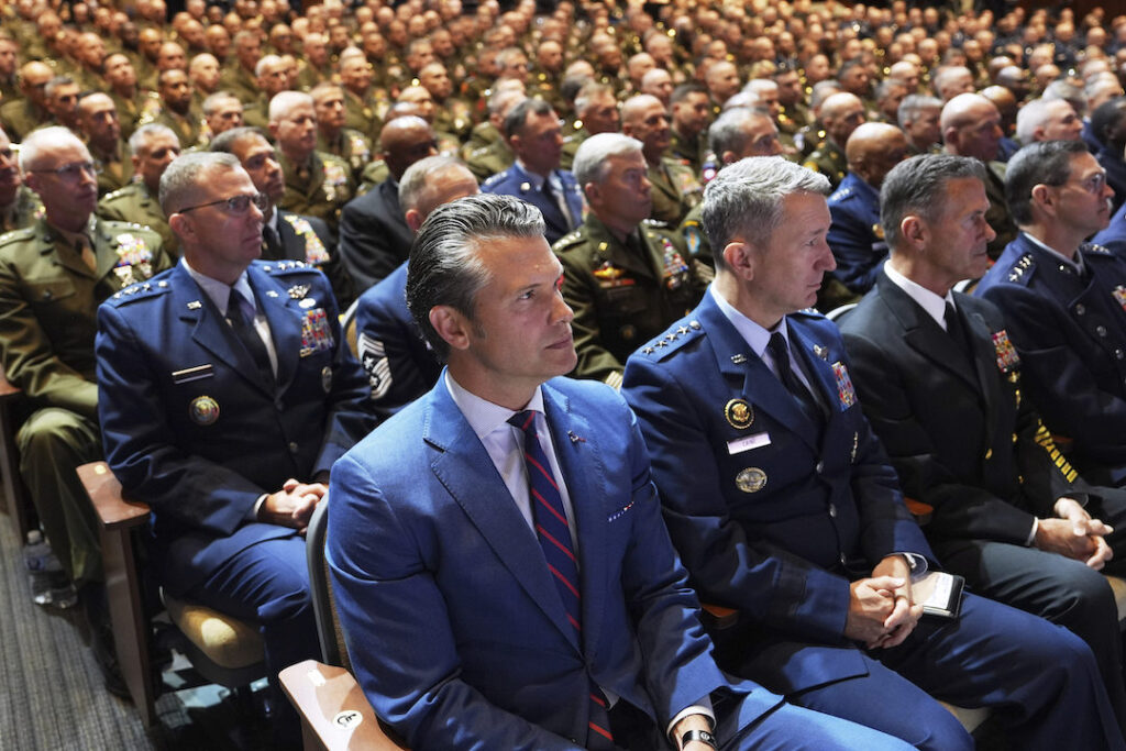 APTOPIX Trump Pentagon Commanders Meeting Defense Secretary Pete Hegseth, center, sitting with Chairman of the Joint Chiefs of Staff Air Force Gen. Dan Caine, third from right, and U.S. military senior leadership as they listen to President Donald Trump speaks at Marine Corps Base Quantico, Tuesday, Sept. 30, 2025 in Quantico, Va. (AP Photo/Evan Vucci)