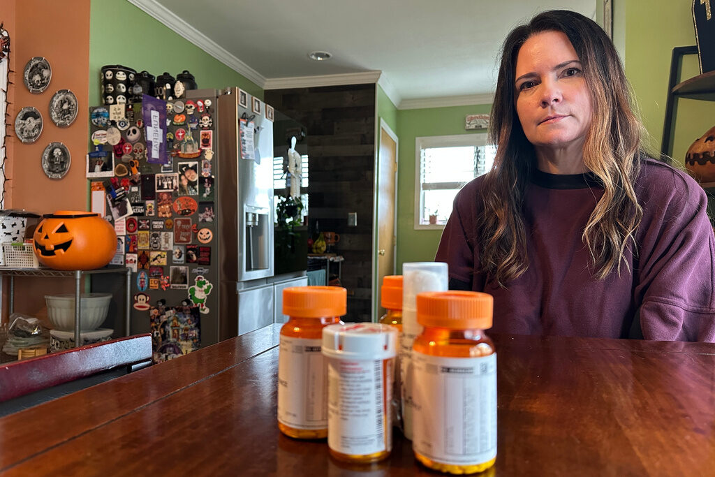 ACA Tax Credit Local hair stylist Christine Meehan sits in front of her medication