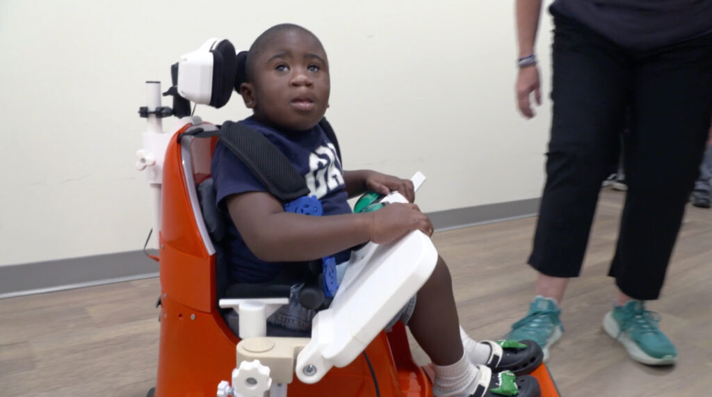 YOK Little boy in assistive device