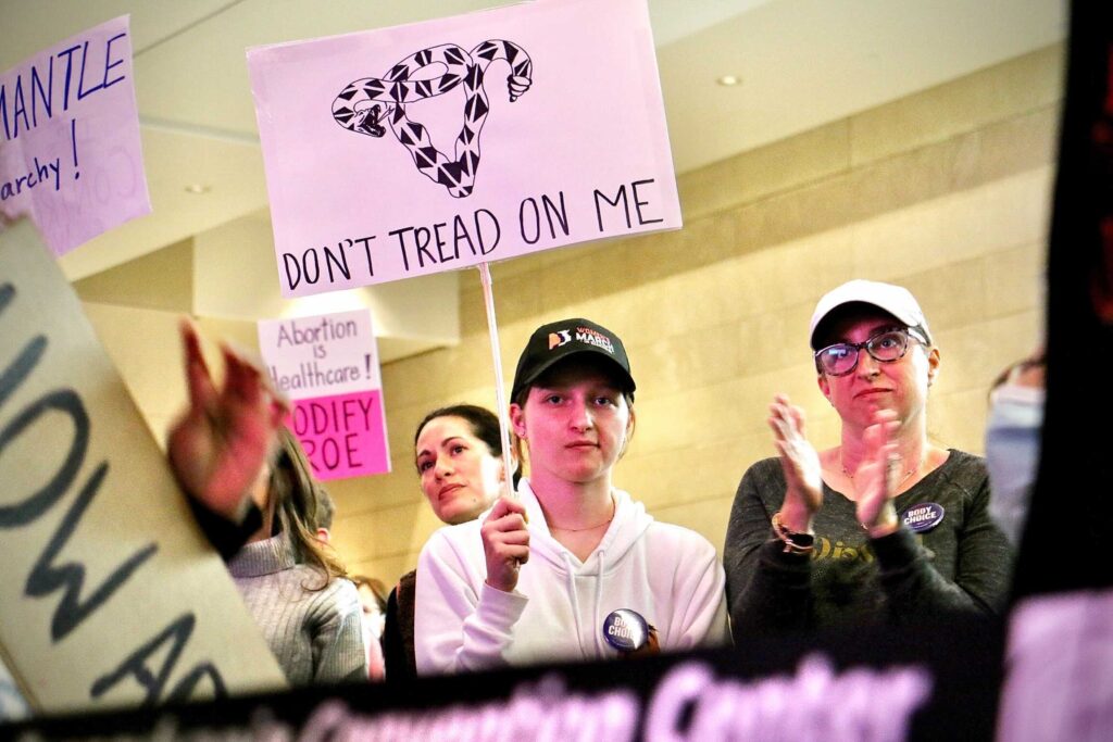 abortion-rights-rally-josh-shapiro-e-lee-20220506-3-file an abortion rights rally, with the most prominent sign reading DON'T TREAD ON ME