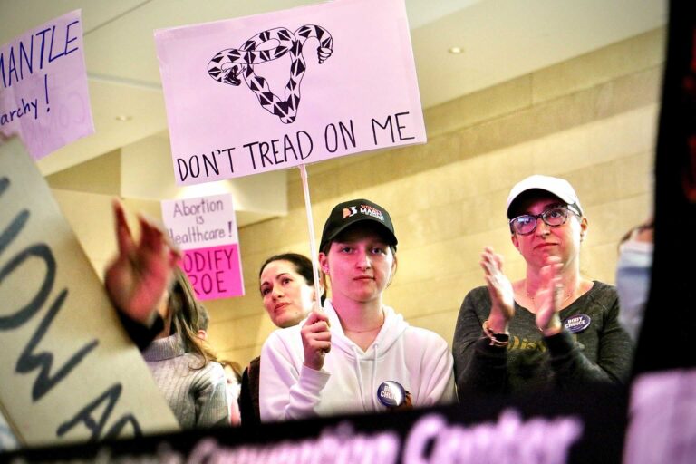 an abortion rights rally, with the most prominent sign reading DON'T TREAD ON ME