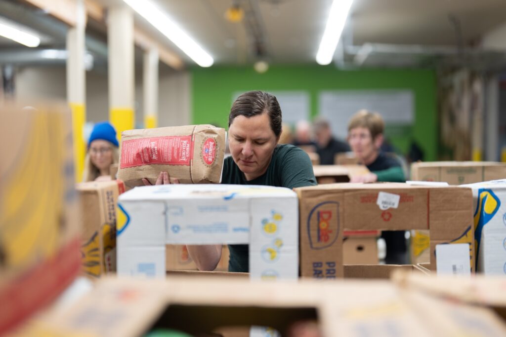APTOPIX Government Shutdown Food Aid People working sorting food at a food bank
