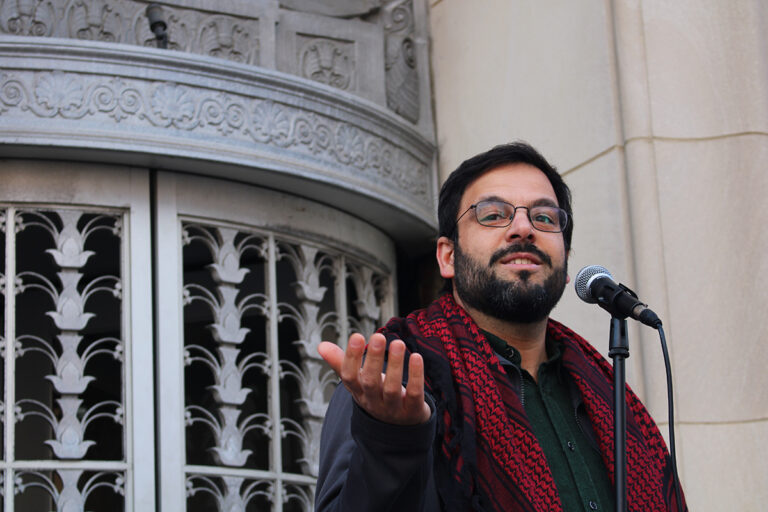 Ahmet Selim Tekelioglu, executive director of CAIR-Philadelphia, speaks into a microphone outside of Sen. John Fetterman's Old City office