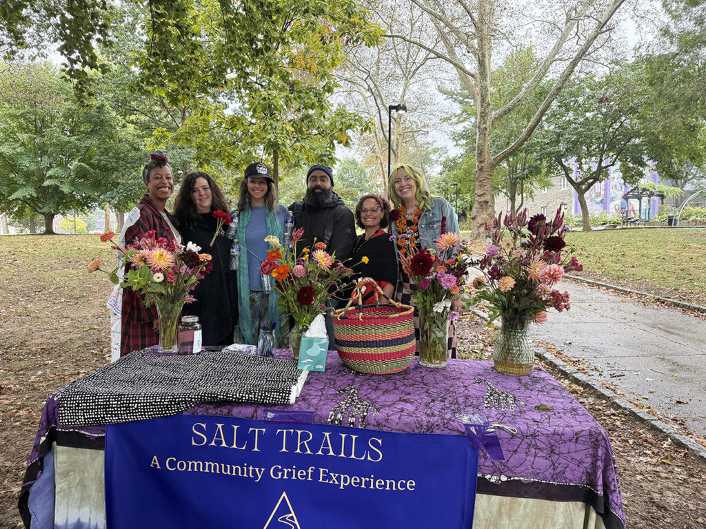 grief_processional_philadelphia8 Salt Trails Philly organizer pose for a photo in front of a table