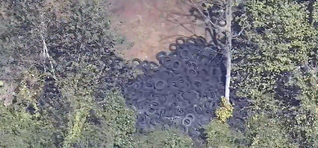 An aerial shot of tires in a forested area near Northeast Philadelphia Airport