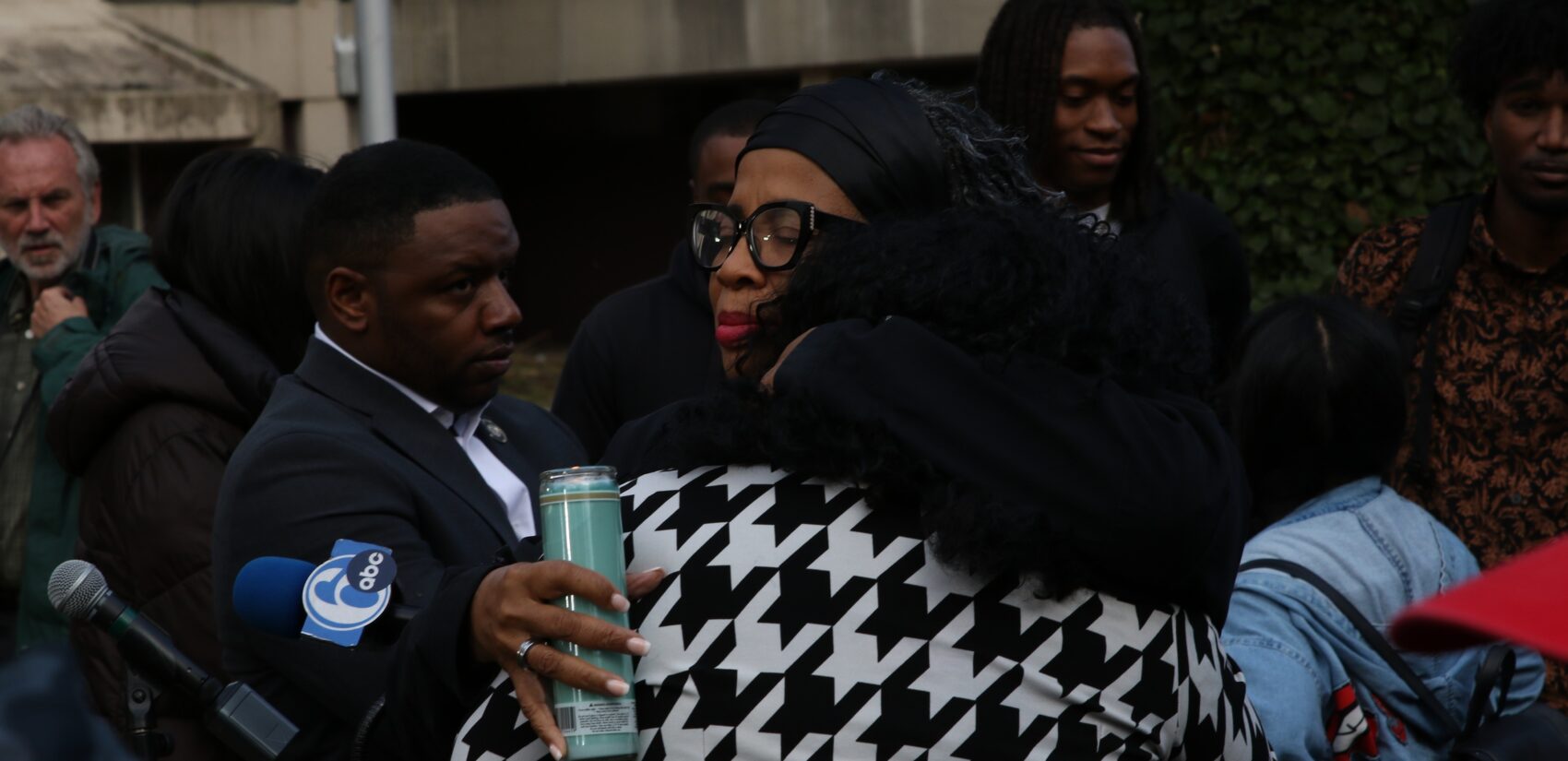 Two people hug at the Kada Scott vigil