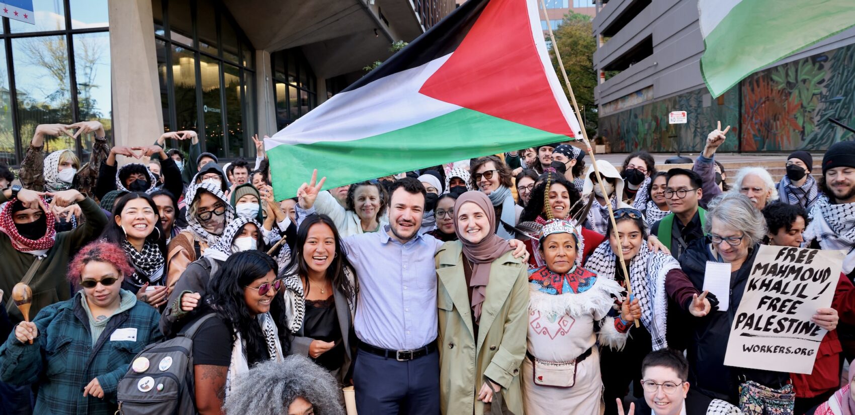 Mahmoud Khalil poses with protesters