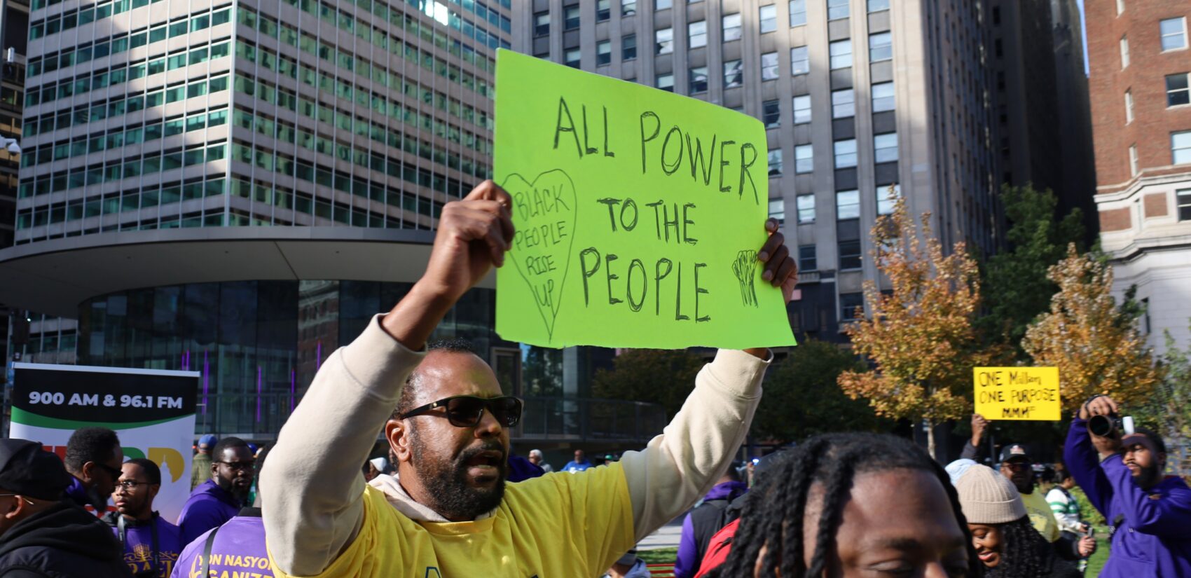 a Philadelphian holds a sign reading ALL POWER TO THE PEOPLE BLACK PEOPLE RISE UP
