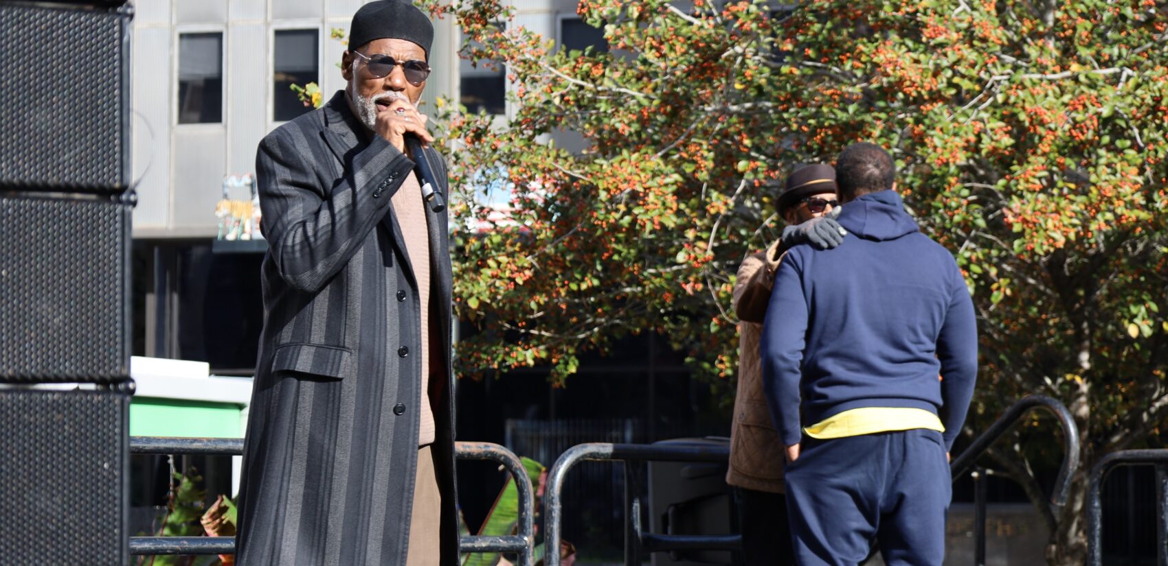 Kenneth Salaam speaks into a mic