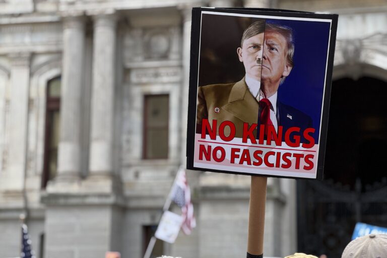 ‘’No Kings’’ protesters gather at Philadelphia City Hall on Oct. 18, 2025. A sign reads 