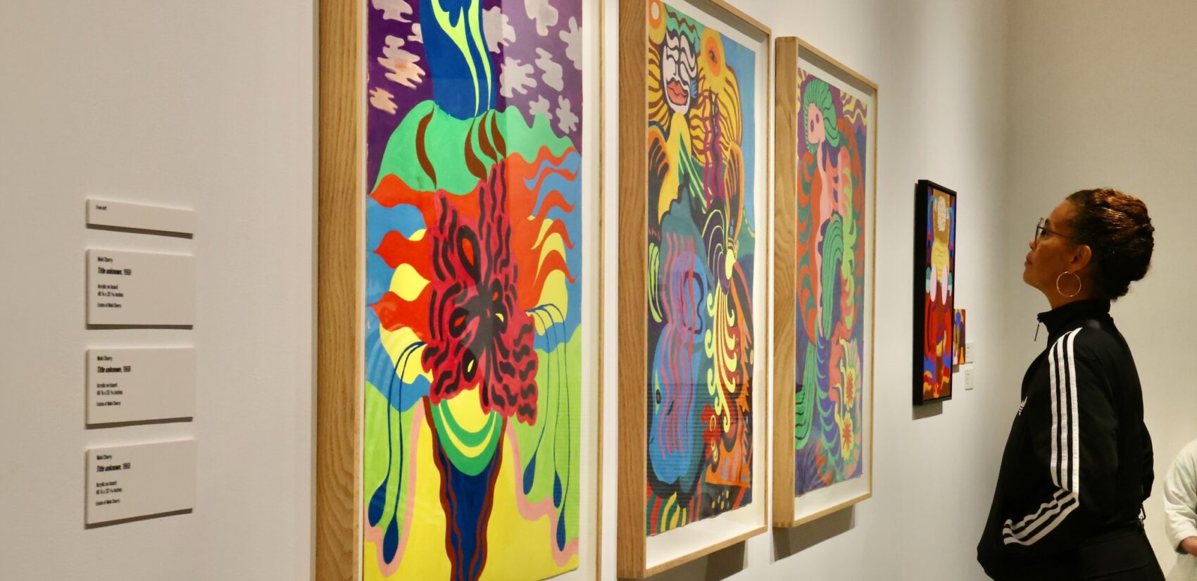 Moki Cherry's daughter, Neneh Cherry, looks at some of her mother's paintings