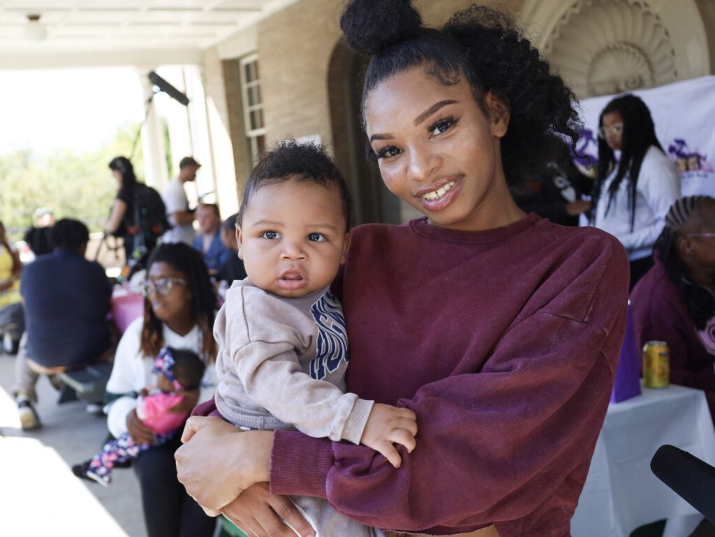 A woman holding a baby