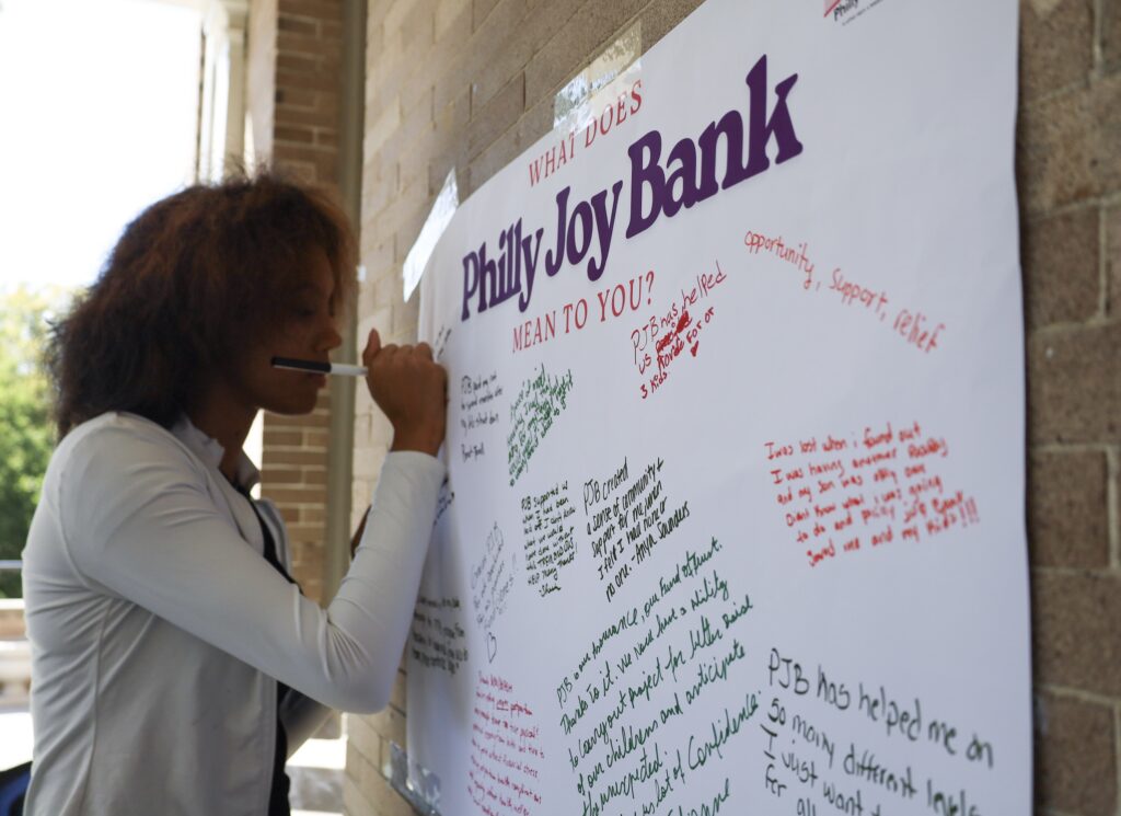 A woman writes on a dry erase board