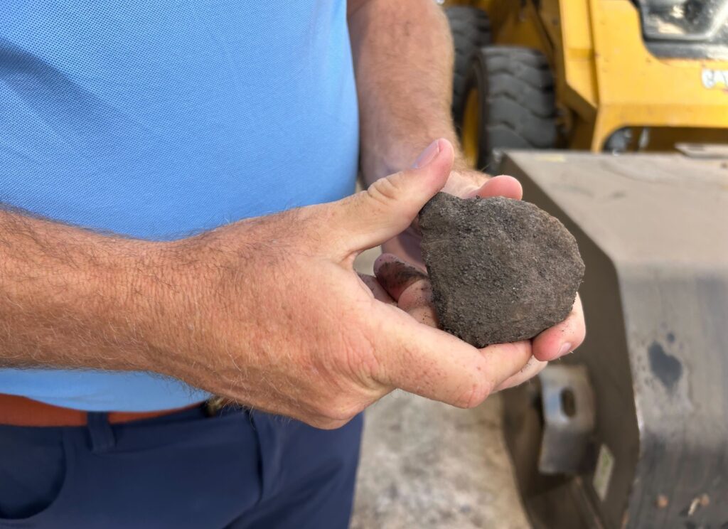 A man holding a piece of biocoal