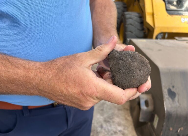 A man holding a piece of biocoal