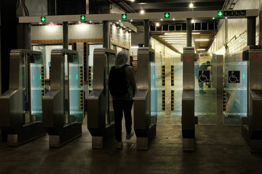 septa-full-length-fare-gate-2025 a SEPTA rider walks through the full-length fare gates