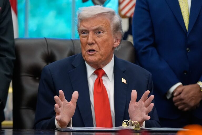 President Donald Trump answers questions from reporters in the Oval Office at the White House, Tuesday, Oct. 21, 2025, in Washington.