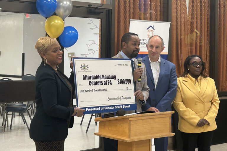 State Sen. Sharif Street presents a $100,000 check from the state to support the Will Power Program.