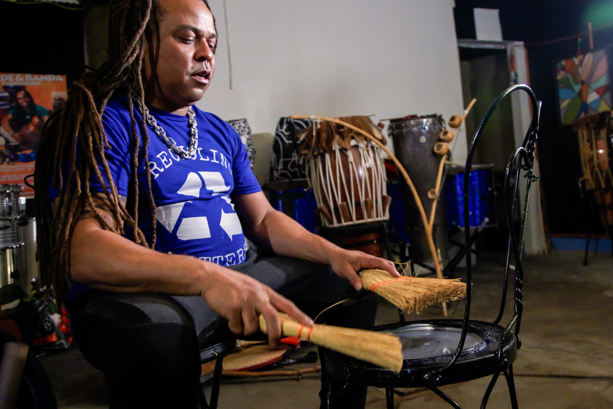 Dendê Macêdo uses recycled brooms and a trash-picked metal chair to play Afro-Brazilian rhythms