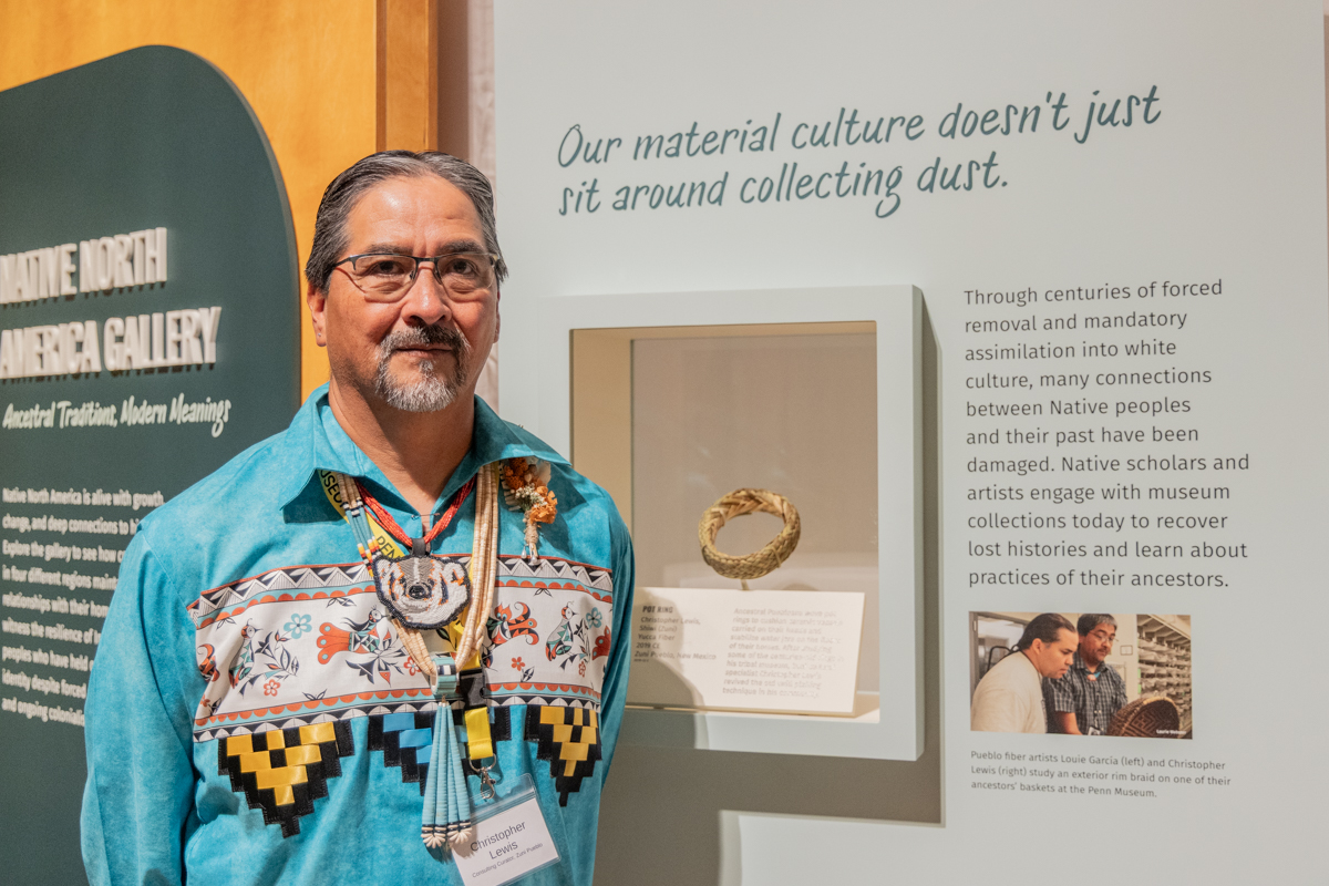 Christopher Lewis stands with his artwork at Penn Museum