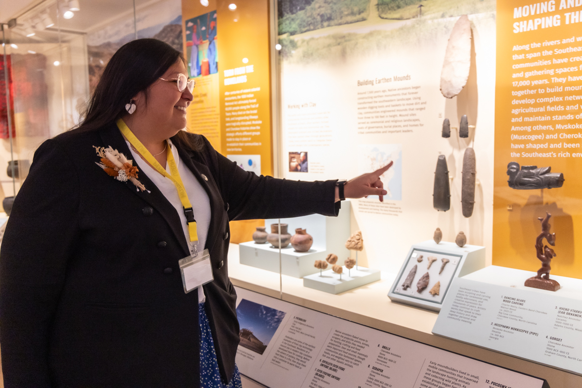 RaeLynn Butler pointing at native american relics at the Penn Museum
