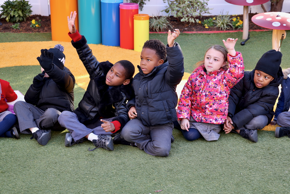 Kindergarten students volunteer to start a game of duck duck goose