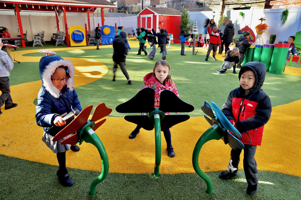 children playing with metal flowers