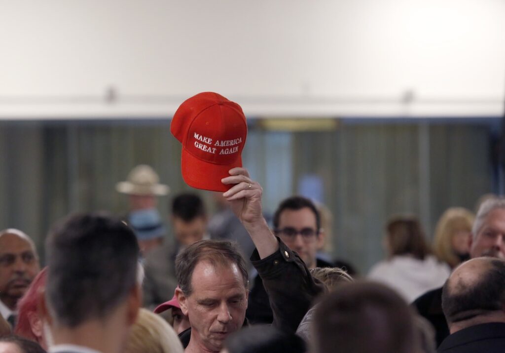 A member in the audience holds up a 