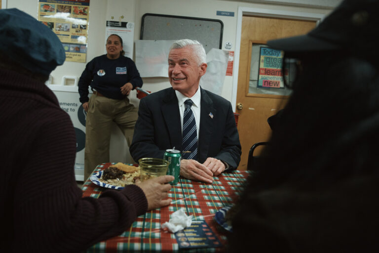 Jersey City mayoral candidate Jim McGreevey, center, listens during a community event