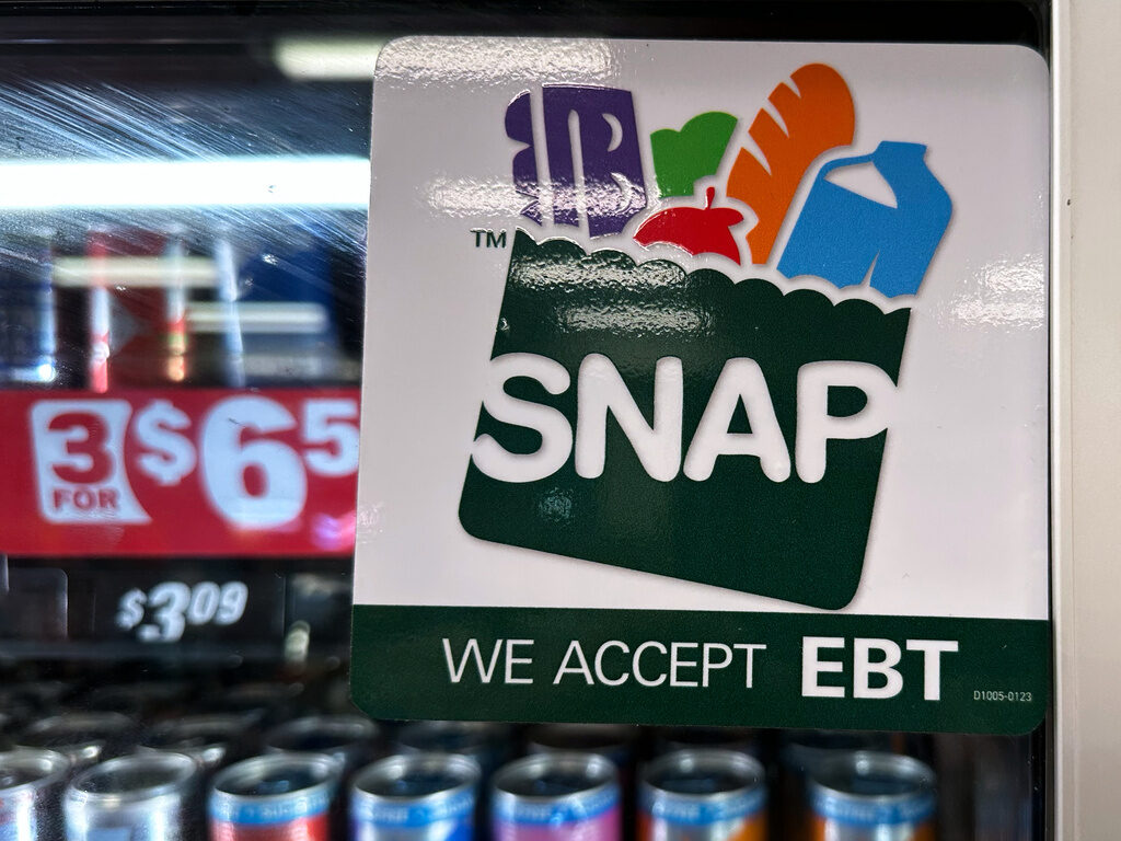 Government Shutdown Food Aid SNAP EBT information sign is displayed at a gas station