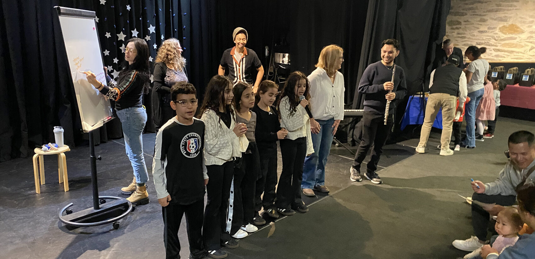 Professional musicians lead a songwriting workshop with kids and families at the Please Touch Museum’s Wonder Theater.