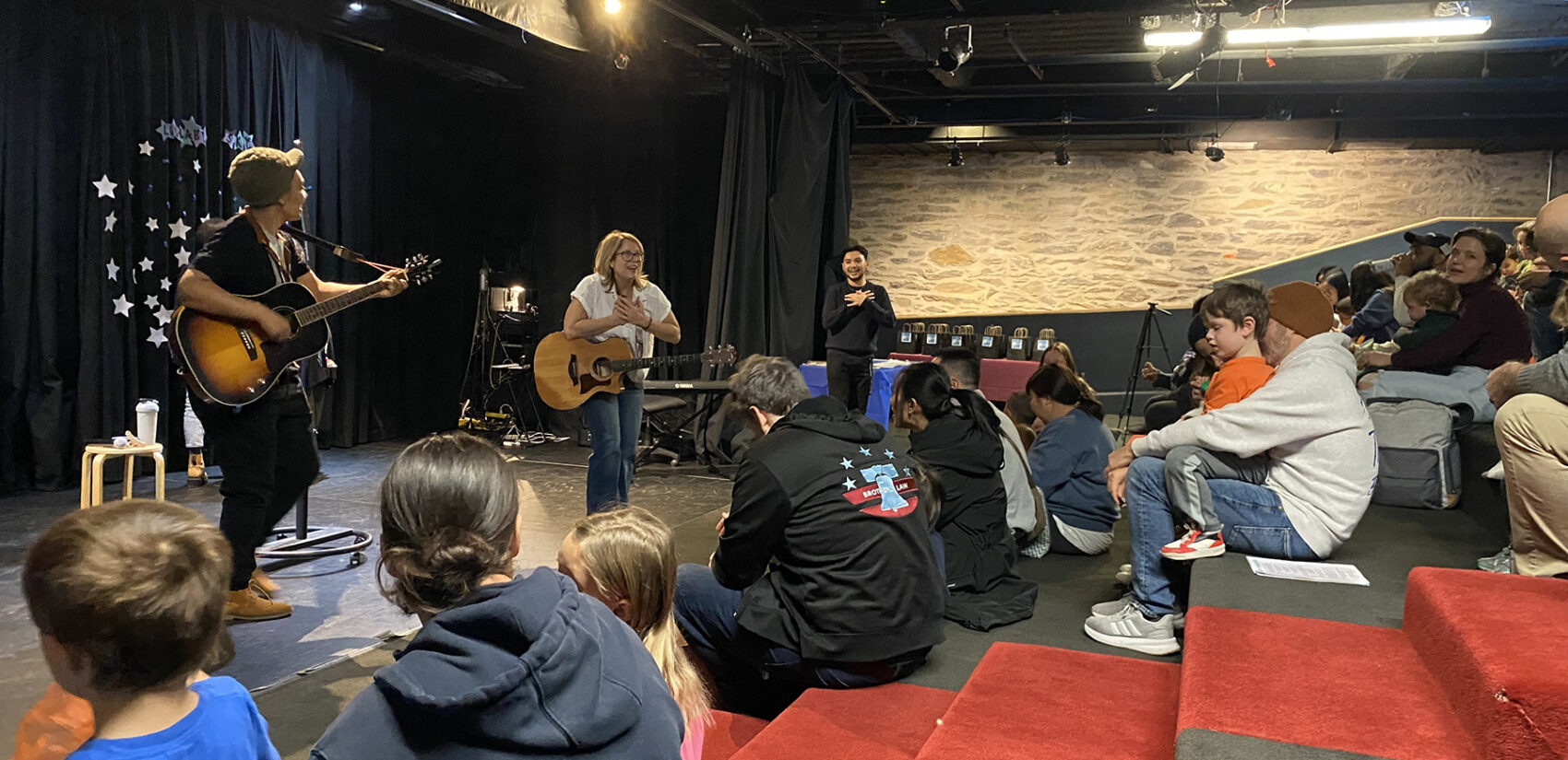 Professional musicians lead a songwriting workshop with kids and families at the Please Touch Museum’s Wonder Theater.