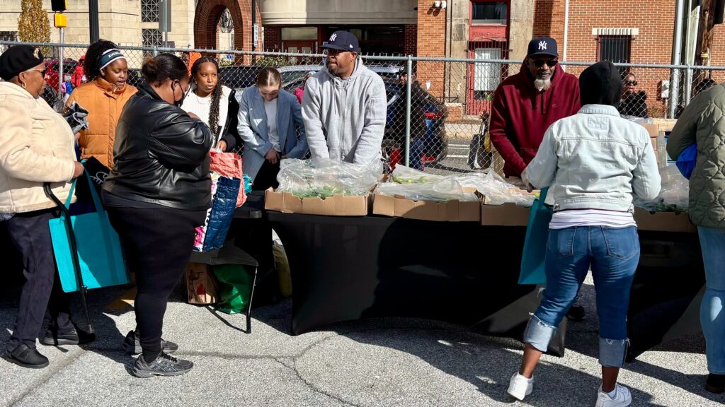 Wilmington-YMCA-food-2025-11-06-1 Volunteers hand out fresh produce and other groceries at a food giveaway event at the Wilmington YMCA