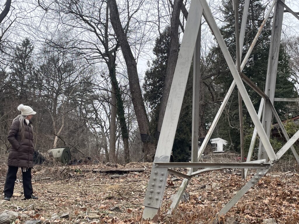 delmarva-power-c-barrish-2025-11-19-4 Lisa Wilson Riblett standing next to a transmission tower