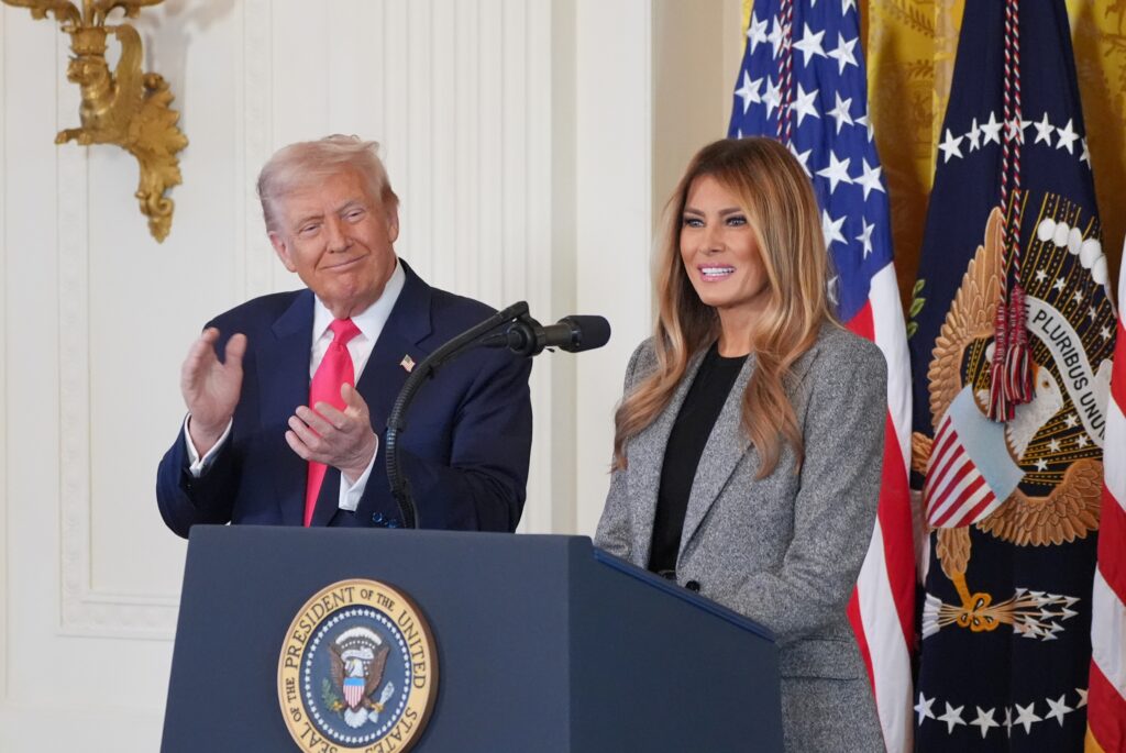 donald-melania-trump-2025-11-13 President Donald Trump listens as first lady Melania Trump speaks