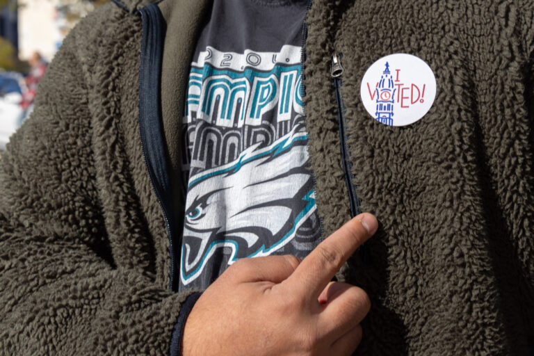 A voter shows off their election sticker in Philadelphia